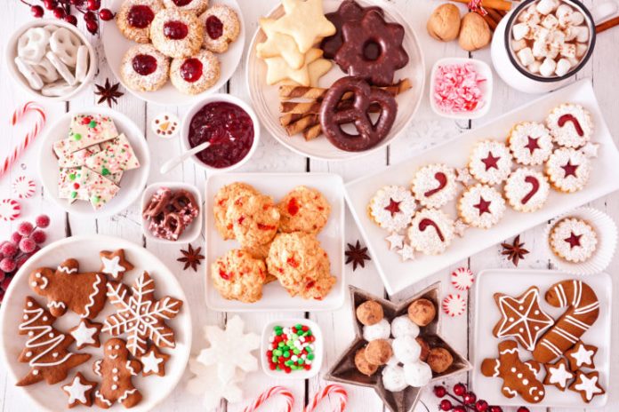 a collection of christmas cookies on a white table. This party food does not look healthy
